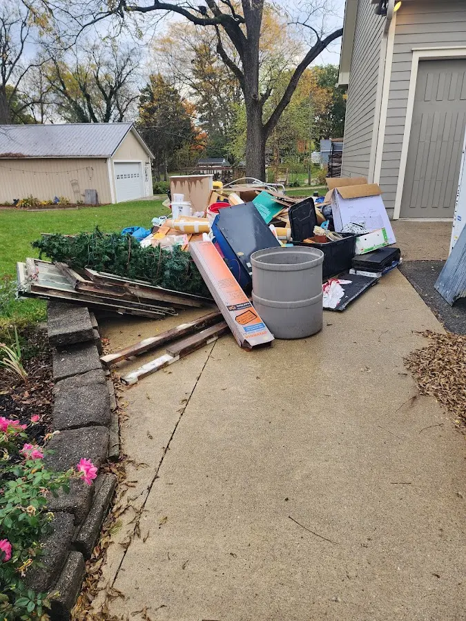 Dumpster being loaded with debris for Residential Dumpster Rental in Brookings
